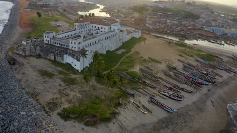 Aerial-shot-of-the-Elimina-castle-in-Ghana-during-sunset