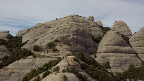 Aerial-Shot-Of-Montserrat-Mountain-Range-With-Tourism-Trail-To-A-Chapel