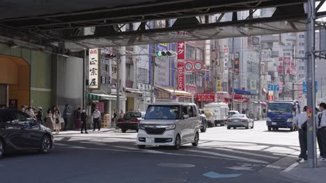 Traffic-on-Japanese-Road-at-Tsuruhashi-street,-Pan-to-the-right-shot-during-day