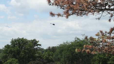 A-private-helicopter-flying-over-the-rural-countryside-on-a-sunny-day