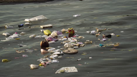 Close-up,-plastic-garbage-trash-floating-on-river-water