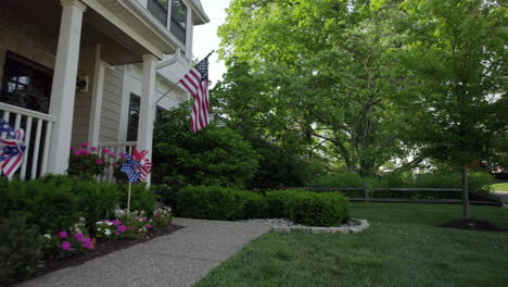 Push-past-front-of-a-nice-house-decorated-with-patriotic-decorations-and-an-American-flag