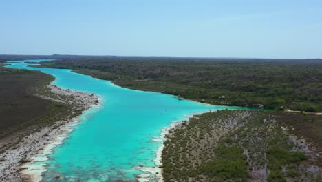 beautiful-turquoise-blue-tropical-Bacalar-Lagoon-in-Mexico-on-sunny-day,-aerial