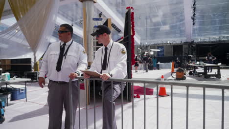 Two-Security-Guards-Stand-Outside-the-Oscars-Stage-while-it's-Under-Construction