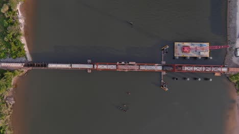Birds-eye-view-of-train-traveling-over-the-Calcasieu-River-in-Lake-Charles,-Louisiana