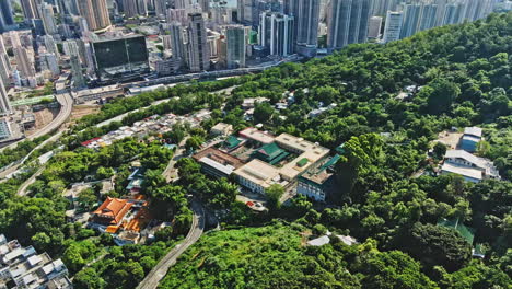 Aerial-drone-shot-of-old-temple-in-Tsuen-Wan,-Hong-Kong-cityscape