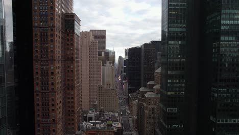 Aerial-view-over-the-7th-Avenue,-in-Manhattan,-New-York-city,-USA---reverse,-drone-shot