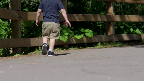 A-child-walking-on-a-path-outside