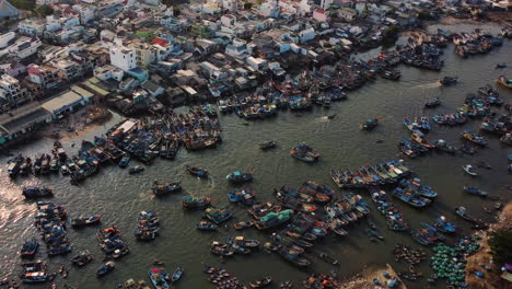 Top-down-view-on-boats-crowded-in-fishing-harbor-in-La-Gi-town,-Vietnam