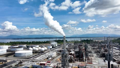 Drone-shot-approaching-a-fume-smokestack-at-an-oil-refinery-in-Washington