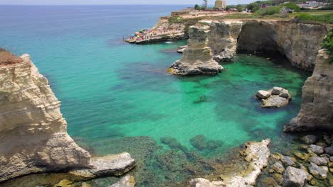 4K-aerial-of-the-rock-formations-of-Sant'Andrea-near-Torre-Dell'Orso,-Apulia,-Italy-in-the-summer