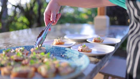 private-chef-plating-appetizers-at-poolside-dinner-party-smoked-ahi-crostini
