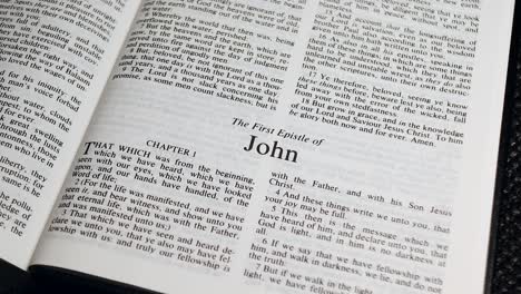 Close-Up-Shot-of-Bible-Page-Turning-to-the-book-of-First-John