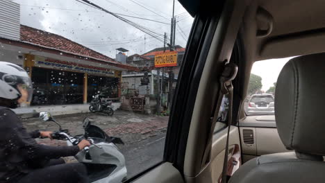 POV-interior-of-car-driving-through-a-town-in-Bali,-Indonesia