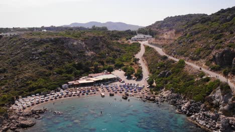 birds-eye-view-rising-up-over-anthony-quinn-bay-in-rhodes-island-showing-the-whole-environment-with-the-mountains