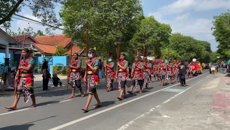 The-parade-of-royal-soldiers-or-Bregodo-in-historical-costumes-during-the-celebration-of-the-founding-of-the-city-of-Bantul,-they-are-very-energetic-and-charismatic-when-walking