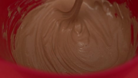 Close-up-view-inside-the-bowl-while-whisking-together-ice-cream-and-chocolate
