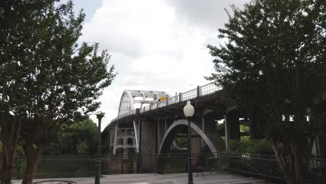 Edmund-Pettus-bridge-in-Selma,-Alabama-with-gimbal-video-walking-forward-through-trees-in-slow-motion