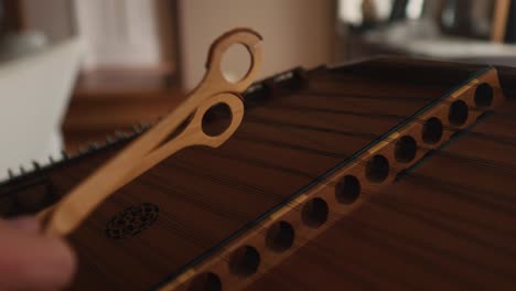 wooden-dulcimer-string-classic-instrument-close-up,-wooden-sticks-hammering-for-melody-and-harmonic-sounds