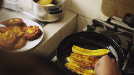 woman-frying-ripe-bananas-in-a-pan-with-oil