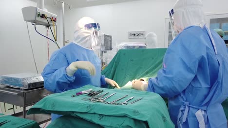 Asian-Surgeon-Wear-PPE-Perform-Upper-Body-Surgery-For-Contagious-Patient-In-Operating-Room