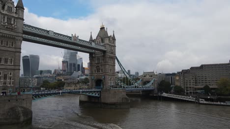 Boat-crossing-the-Tower-Bridge-in-the-Thames-River,-London