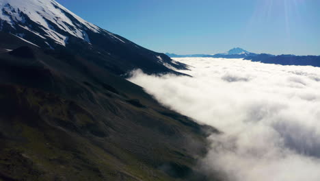 Aerial-truck-shot-showing-the-mountain-ranges-of-National-Park-Vicente-Perez-Rosales-in-Chile,-low-lying-clouds