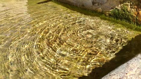 Close-up-of-an-stone-fountain-from-a-small-town-full-of-crystal-clear-water
