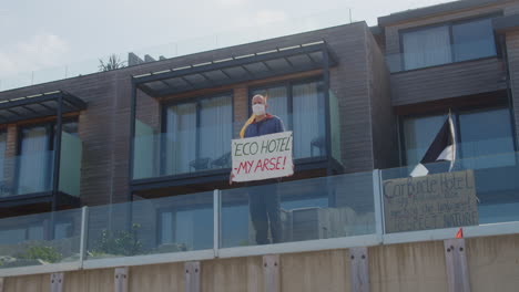 Angry-Man-Protester-Stands-on-Carbis-Bay-Hotel-Beach-Front-Balcony,-Cornwall