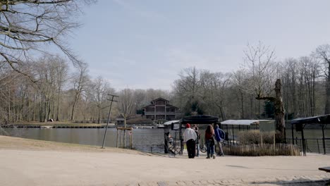 Wide-shot-showing-tourist-in-line-waiting-for-ferryboat-during-beautiful-weather-at-Bois-de-la-cambre-Lake-in-Brussels