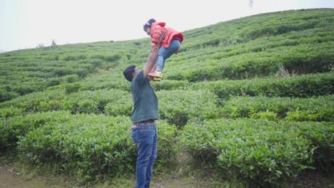 Asian-father-plays-with-his-little-cute-daughter,-throws-in-air-and-catches,-vacation-in-tea-garden,-single-parent-after-divorce