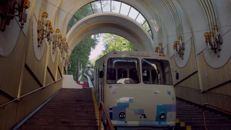 Tilt-down-from-ornate-ceiling-to-carriage-of-Kiev-Funicular-in-Podil-Station