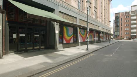 Lockdown-in-London,-closed-Harrods-department-store-in-empty-Knightsbridge-streets-with-rainbow-window-displays,-during-the-Coronavirus-pandemic-2020