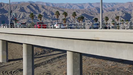 Traffic-on-American-Interstate-10-highway-viaduct-in-California-desert-landscape