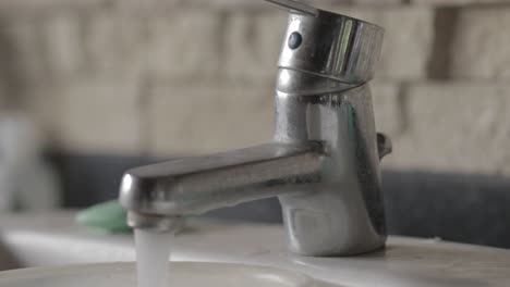 Old-Faucet-with-Running-Water-Being-Turned-on-and-off-in-Close-up-4K-Footage