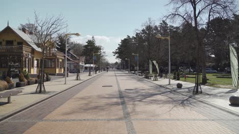 Basanaviciaus-Central-Pedestrian-Street-of-Palanga-With-Only-A-Few-People-Walking-in-Springtime