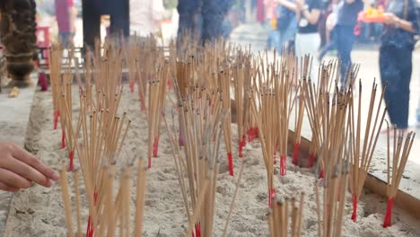 Close-Up-Footage-of-Lots-of-Incense-In-The-Ash-Vase-In-Chinese-Temple