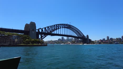 Tracking-shot-towards-Sydney-Harbour-Bridge-on-a-sunny-day