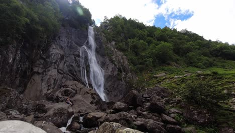 Timelapse-tourist-visitors-climbing-wet-jagged-waterfall-rocks-Aber-falls-North-Wales