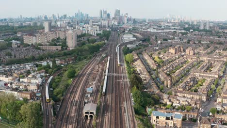 Stationary-drone-shot-of-busy-British-rail-train-tracks-towards-London-city-centre