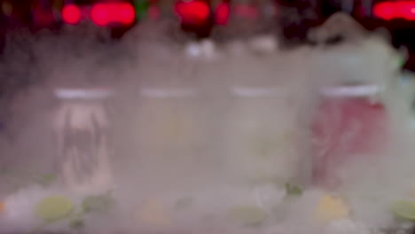Smoke-Reveal-Of-Colourful-Frozen-Smoothie-Jars-On-Bar