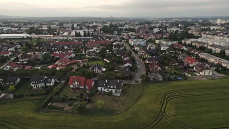 Beautiful-right-movement-shot-of-house-in-country-side-and-green-land-on-cloudy-day-Ariel-shot