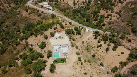 Aerial-View-Of-Modern-Mansion-With-Swimming-Pool-In-The-Mountain-On-A-Sunny-Summer-Day