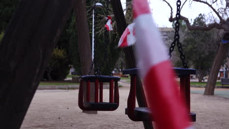 playground-for-children-with-swings-closed-with-tape-signaling-the-prohibition-of-playing---coronavirus