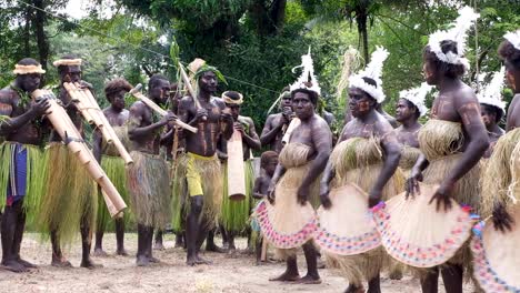 Traditional-bamboo-band-with-unique-instruments-at-cultural-sing-sing-music-festival-by-Bougainville-women-and-men-on-tropical-island-in-Bougainville,-Papua-New-Guinea