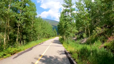 Cycling-along-a-nature-trail-in-the-Colorado-Rocky-Mountains-in-summer-along-a-river