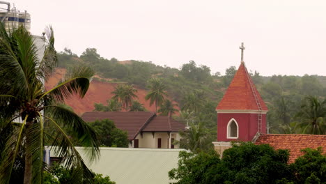 Roof-Of-Church-Cathedral-With-Cross-In-Tropical-Rural-Village,-Gloomy-Windy-Day