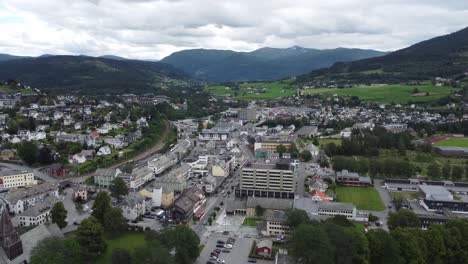Aerial-overview-of-Voss-town-center---Moving-backwards-while-giving-panoramic-view-over-Voss-at-overcast-summer-day