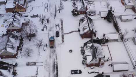 an-aerial-view-of-a-suburban-neighborhood-in-the-morning,-after-a-snow-storm