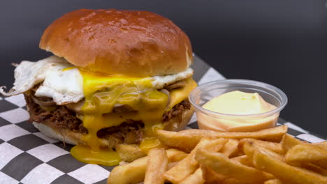 Burger-Bun-Being-Placed-Onto-Fried-Egg,-Dripping-Yolk